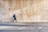 Fototapeta Londyn - Young Man Walking With His Bike And Holding A Coffee Cup In The City.
