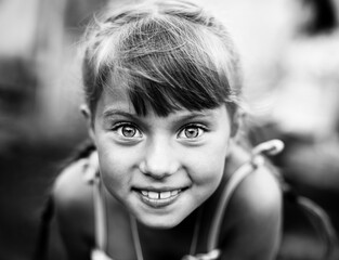 Wall Mural - Close-up portrait of an emotional little girl. Black and white photo.