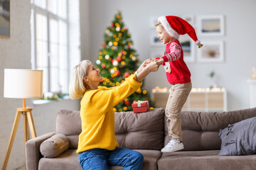 Sticker - Cheerful woman playing with cute boy at home