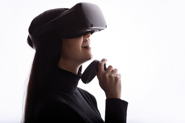 Wall Mural - girl in glasses of virtual reality with controllers in hands. augmented reality concept. free space 