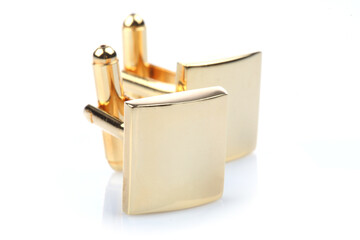 Gold cuff links on white background