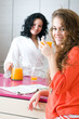 © Tandem - two girls having breakfast in the kitchen