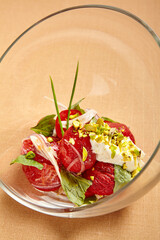 Canvas Print - Tomatoes with stracciatella in round transparent glass bowl