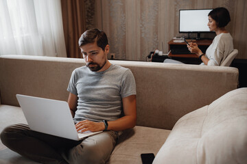 Couple Working And Playing With Laptop Computer At Home