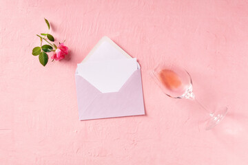 Wall Mural - Romantic greeting card mockup, a flat lay with a pink rose and rose wine