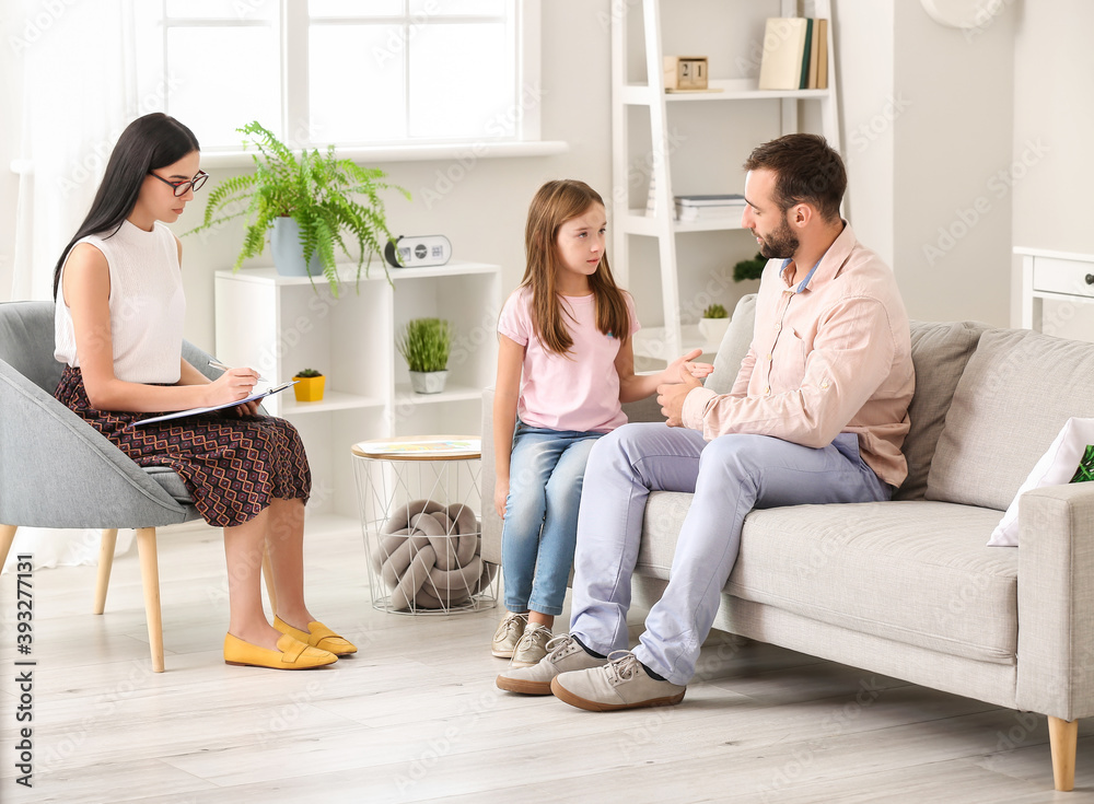 Female psychologist working with family in office