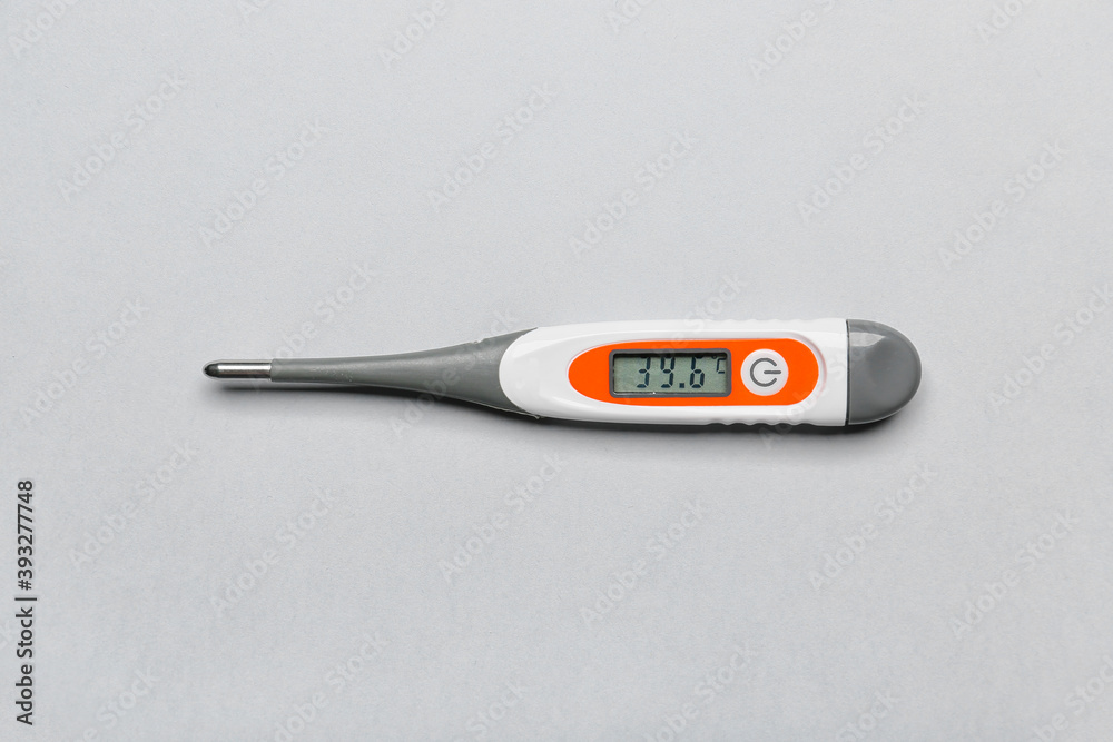 Electronic thermometer on light background