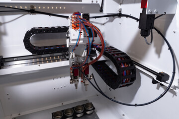 Poster - Fragment of a CNC machine close-up. Robotic production machine. Numerical control equipment. Concept - sale of production equipment. Modern production equipment. Spot welding robot