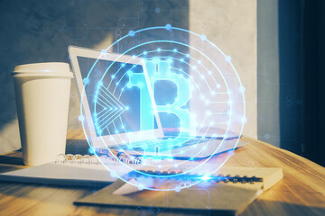 Double exposure of blockchain theme hologram and table with computer background. Concept of bitcoin crypto currency.