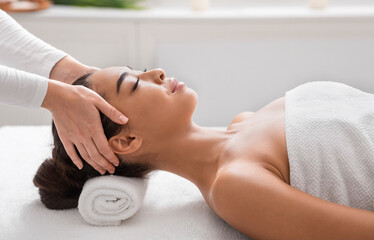 Wall Mural - Relaxed asian lady getting head massage in spa salon, enjoying beauty treatment