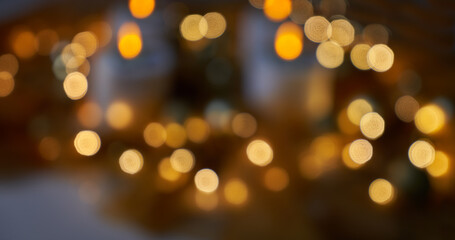 blurry background of shiny golden christmas lights against dark background - can also be used for di