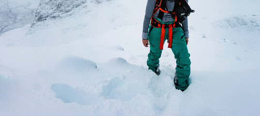 Wall Mural - Woman hiking on a snowy mountain