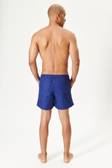 Wall Mural - Man in swimming shorts blue board shorts