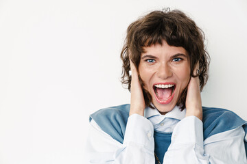 Excited beautiful girl screaming and covering her ears