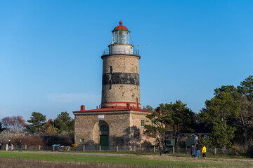 A brick lighthouse with a bright blue sky in the background. Picture of Falsterbo Lighthouse built in 1796, Scania, Sweden