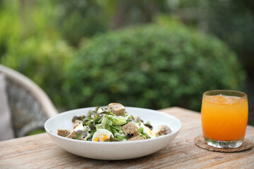 Wall Mural - caesar salad appetizer on wooden background