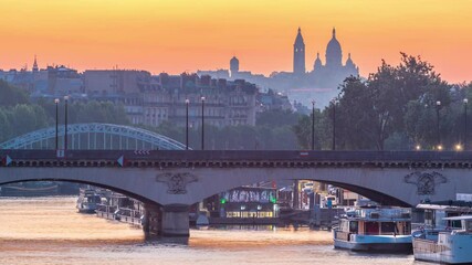 Wall Mural - Bridge near Eiffel tower and the Seine river night to day transition timelapse before sunrise, Paris, France. Morning view from Bir-Hakeim bridge with reflections on water