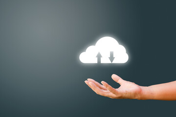 Hand holding white cloud storage computing icon on dark background. Communication of business and financial. Cloud data storage concept.