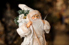 Close-up View Of Toy Santa Claus With Beard In White Hat And Fur Coat