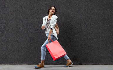 Portrait of beautiful smiling young woman with shopping bags