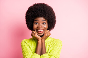 Photo portrait of adorable girl holding face chin with two hands isolated on pastel pink colored background