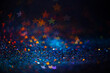 Leinwandbild Motiv Festive twinkle lights background, abstract sparkle backdrop with stars, modern design overlay with sparkling glimmers. Blue, orange and green backdrop glittering sparks with blur effect