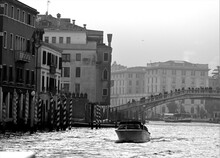 Venice, Italy, December 28, 2018 Evocative Black And White Image Of Typical Venice Canal With Motorboat In Motion
