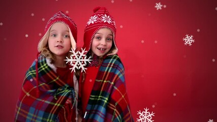 Poster - Animation of two girls in woolen hats with snow falling on red