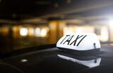 Fototapeta  - taxi in the city - order by apps - dark background