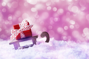 Santa's sleigh with red gift box in snow over holiday background with copy space. Christmas and New Year concept