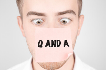Poster - man with a red sticker on his nose reads the text q and a