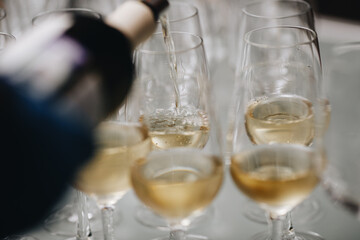 Waiter is pouring champagne into glasses, Champagne