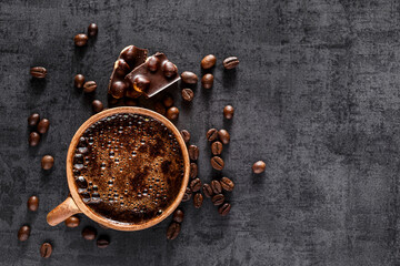 Wall Mural - Freshly brewed espresso on a black stone table cup. Roasted arabica and robusta coffee beans.Coffee beans wallpaper.Top view, flat lay with copy space for your text.