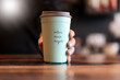 © Daniel Ingold/Westend61 - Hand holding deposit cup for Coffee to go, close-up