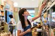 © BONNINSTUDIO/Westend61 - Woman with tablet at shelf in a store