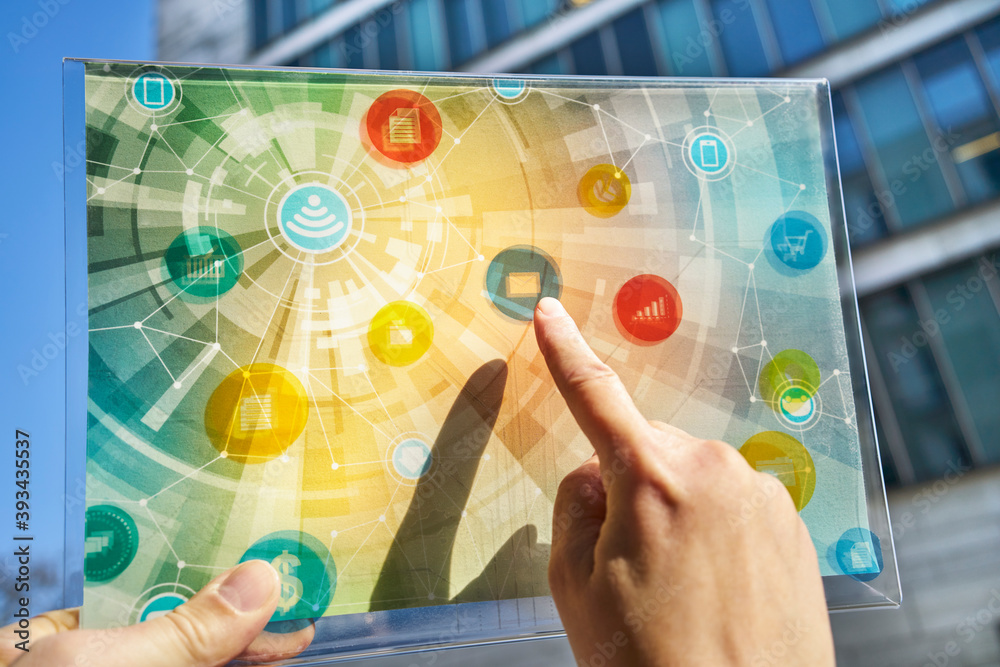 Hand holding futuristic device with digital icons Stock Photo | Adobe Stock
