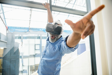 Businessman wearing VR glasses at the window