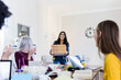 © Giorgio Fochesato/Westend61 - Young women bringing pizza for friends studying at home