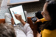 © Giorgio Fochesato/Westend61 - Businesswoman and businessman sharing tablet on sofa in loft office