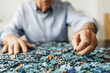 © JOSEP M ROVIROSA/Westend61 - Senior man doing a jigsaw