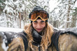 © Juri Pozzi/Westend61 - Portrait of smiling young woman in skiwear in winter forest