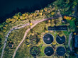 © Konstantin Trubavin/Westend61 - Aerial view of water treatment plant by lake on sunny day