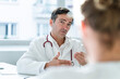© KNSY/Westend61 - Portrait of doctor talking to patient in medical practice