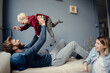 © Kniel Synnatzschke/Westend61 - Happy family playing with their son at home