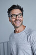 © philipp nemenz/Westend61 - Portrait of laughing man with stubble wearing grey sweatshirt and glasses