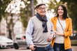 © UWE_UMSTAETTER/Westend61 - Portrait of senior man strolling together with his adult granddaughter