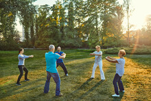 Group Of People Doing Tai Chi In A Park