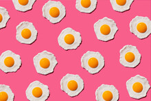 Pattern Of Fried Eggs Against Pink Background