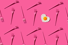 Pattern Of Pink Plastic Forks With Single Heart Shaped Fried Egg