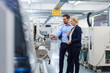 © Robijn Page/Westend61 - Confident young engineer discussing with businesswoman while pointing at machinery in factory